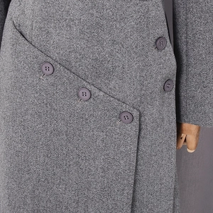 Detailed macro view of gray wool blend coat fabric with five dark resin buttons
