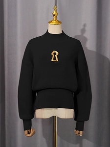 Women's black ribbed knit sweater with gold keyhole hardware and half-high collar