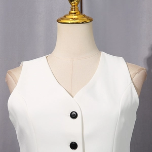 Close-up of white V-neck vest with textured fabric and contrasting black buttons