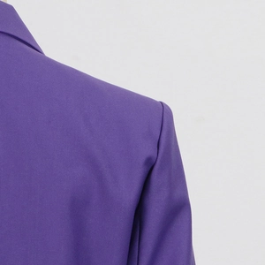 Detail shot of purple blazer showing twill fabric texture and padded shoulder construction