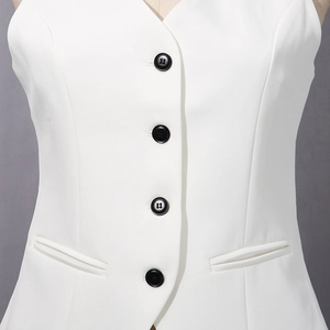 Detail of white business vest with four black buttons and symmetrical side pockets