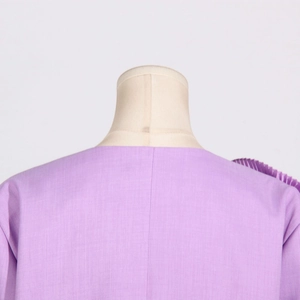 Detail of lavender blazer neck stitch and shoulder pleats on a mannequin stand