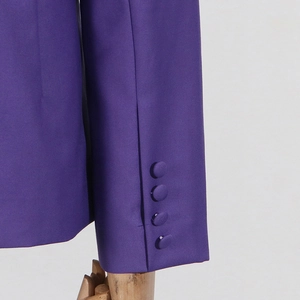 Detailed view of purple blazer cuffs with matching four-button closure and fabric texture
