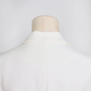 Close-up of back neckline and collar stitch detail on white professional tailored blazer