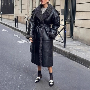 Close-up of black leather trench coat with thick faux fur collar and matching belted waist