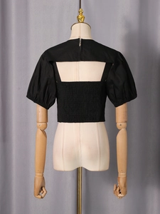 Women's black backless crop top set with smocked waist and puff sleeves back view