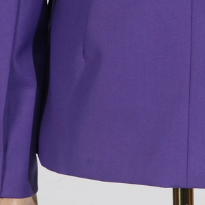 Detailed macro view of deep purple twill fabric and hem stitching on blazer
