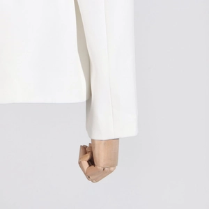 Detail view of white blazer cuffs and hem showing premium fabric texture and clean sewing