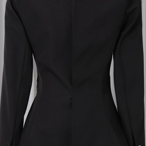 Close-up of slim fit black blazer showing back waist tailoring and sleeve stitching details