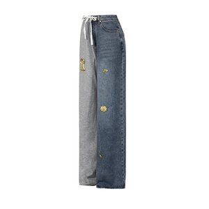Detail of high-waisted wide-leg trousers featuring asymmetrical denim and knit patchwork