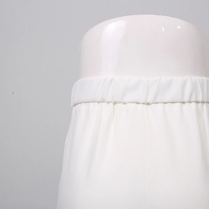 Detailed macro view of the elastic waistband on high-waist white casual fashion trousers