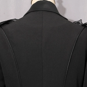 Detail of black blazer with matte leather collar and ruffled shoulder design