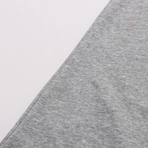 Close-up of grey knitted fabric texture showing premium cotton material and detailed weave