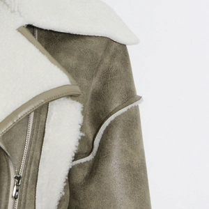 Dettaglio giacca biker in ecopelle grigio-verde con colletto in sherpa bianco e zip argento