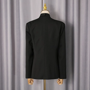 Detail view of the slim-fit black blazer back showing precise central seam and waist tailoring