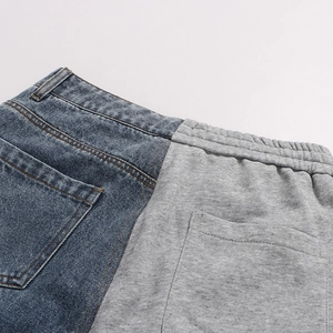 Detail of creative patchwork jeans showing blue denim and grey knit fabric texture