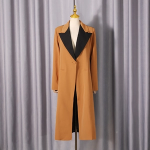 Detail of the black contrast collar and camel long blazer for a chic professional look