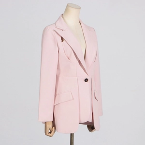 Detail of light pink slim-fit blazer showing notch lapel and classic tortoiseshell button