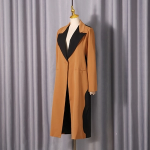 Detailed shot of camel and black color-block blazer coat with classic wide lapels