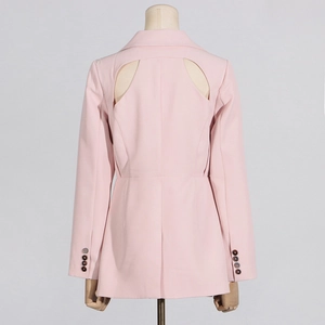 Detail of pink women's blazer featuring symmetrical back cut-out and resin buttons