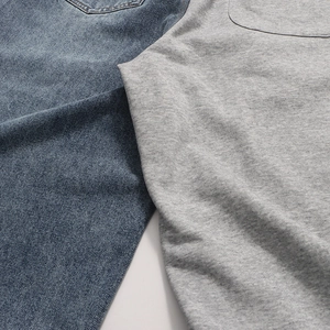 Detailed close-up showing the contrast between dark blue denim and grey knit fabrics