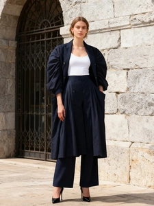 Fashionable navy long trench coat with puff sleeves and wide-leg trousers outfit