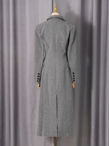 Elegant grey long wool coat with back slit and black buttons on the sleeves