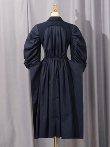 Navy blue puff sleeve dress with open back detail and pleated waist from back view