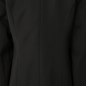 Close-up of the back seam and stitching on a minimalist matte black suit jacket