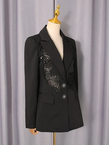 Women's black suit jacket featuring intricate lace floral appliqués and tailored lapels