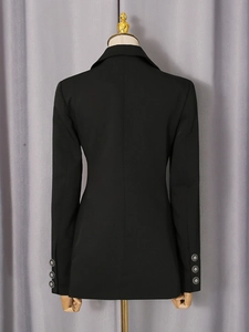 Slim fit black women's blazer with cinched waist and silver embossed buttons on the sleeves