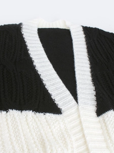 Women's V-neck knit cardigan with black and white contrast stitching and cable pattern