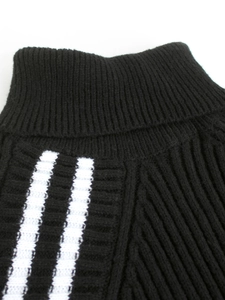 Black knitted turtleneck dress with white side stripes and ribbed texture finish