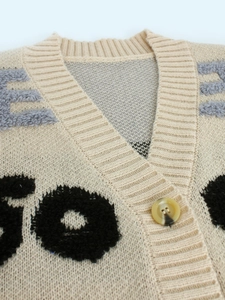 Gilet en maille beige avec col en V et broderie de lettres en relief texturées