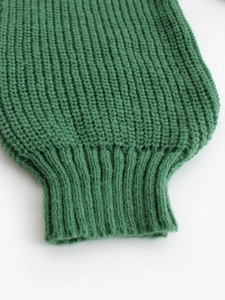 Forest green short knit cardigan featuring elastic ribbed cuffs and premium woven texture