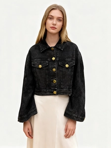 Short black washed denim jacket with golden embossed buttons and oversized cuffs