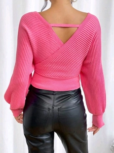 Women's pink V-back knitted sweater with lantern sleeves and rib texture on a white background