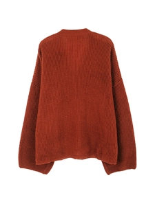 Close-up of caramel knit sweater showing chunky rib texture and drop shoulder design