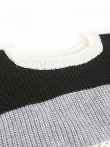 Women's crew neck striped knit sweater with white, black, and grey patchwork patterns