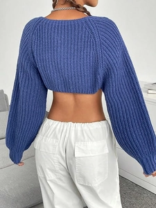 Back view of a blue chunky knit super crop cardigan with long lantern sleeves for women