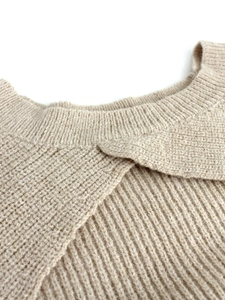 Elegant beige crewneck knit sweater with unique crossover front design and ribbed texture