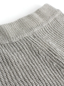 Macro shot of light grey knit fabric detail with ribbed texture and thick weave