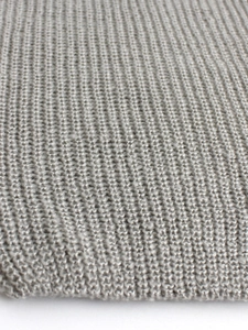 Close-up of premium gray knitted fabric showing detailed stitch pattern and soft texture
