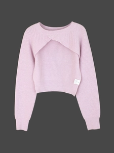 Close-up of pink ribbed knit sweater with unique crisscross layer and laundry care label