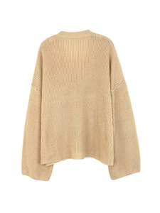 Detail view of apricot chunky knit sweater showing the thick vertical ribbed texture