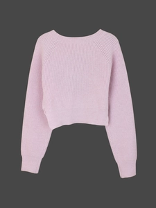 Detail view of pink knit sweater featuring raglan sleeves and ribbed texture surface