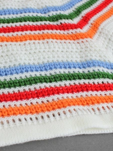 Detailed macro view of multicolor crochet knit fabric with breathable stripe pattern