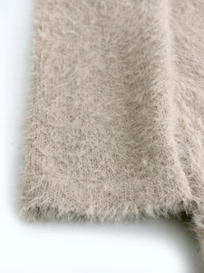 Close-up of fluffy long-hair knit fabric detail for minimalist slim-fit sweater dress