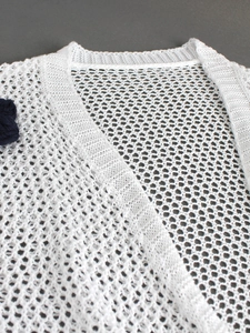 White crochet knit cardigan with hollow mesh design and 3D blue floral shoulder detail
