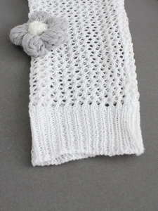 Women's white crochet knit arm warmers with gray floral accents and ribbed cuffs